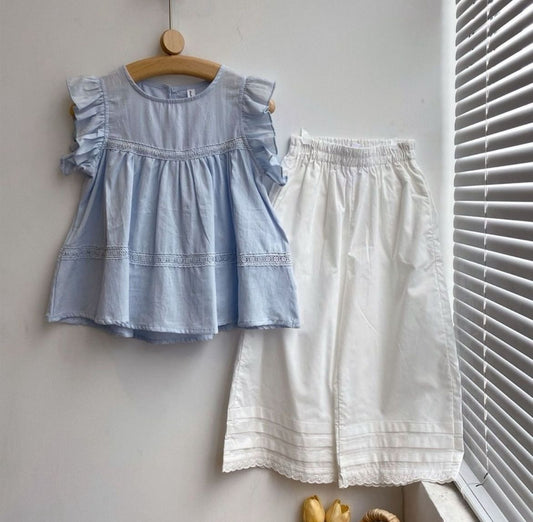 Wide white pants and blue top